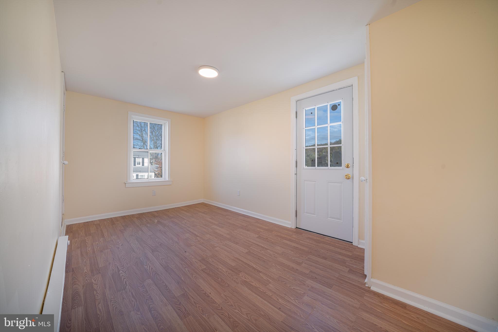 25329 Highfield Road Cascade, MD 21719 - Photo 32 of 51 an empty room with wooden floor and windows