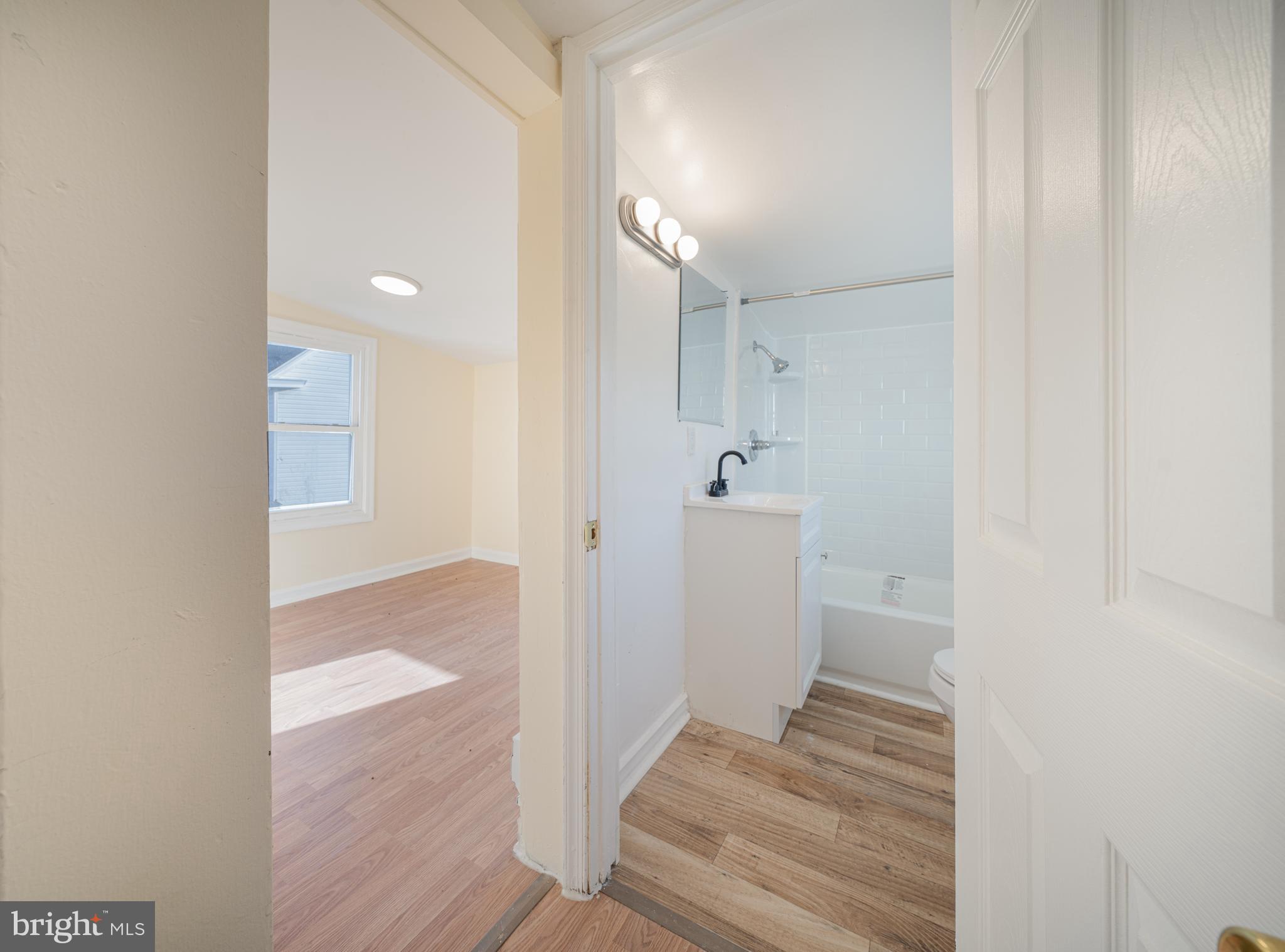25329 Highfield Road Cascade, MD 21719 - Photo 35 of 51 a view of a hallway with wooden floor and a bathroom