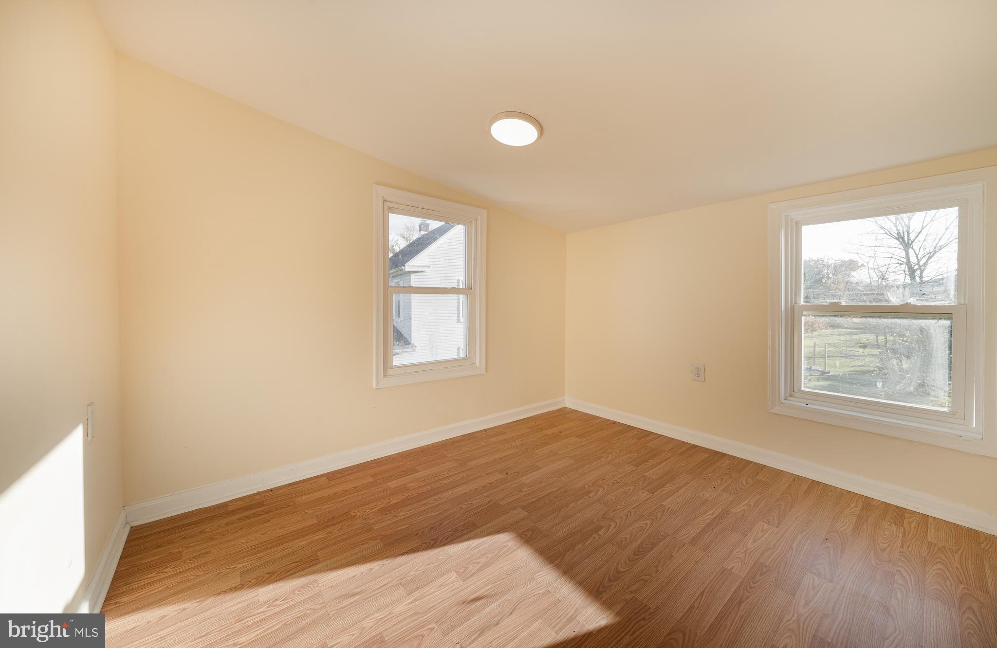 25329 Highfield Road Cascade, MD 21719 - Photo 36 of 51 an empty room with wooden floor and windows