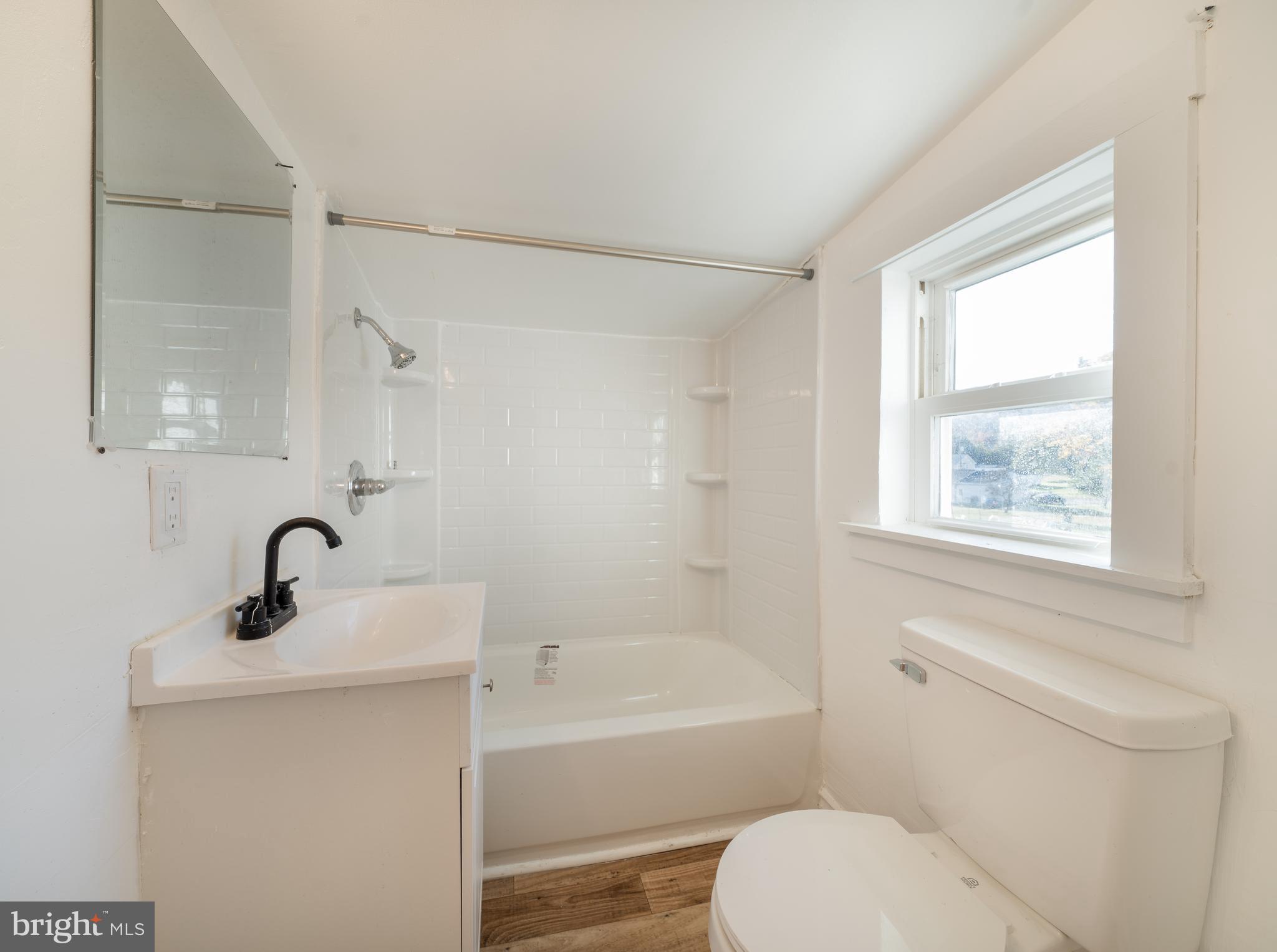 25329 Highfield Road Cascade, MD 21719 - Photo 38 of 51 a bathroom with a sink mirror bathtub and toilet