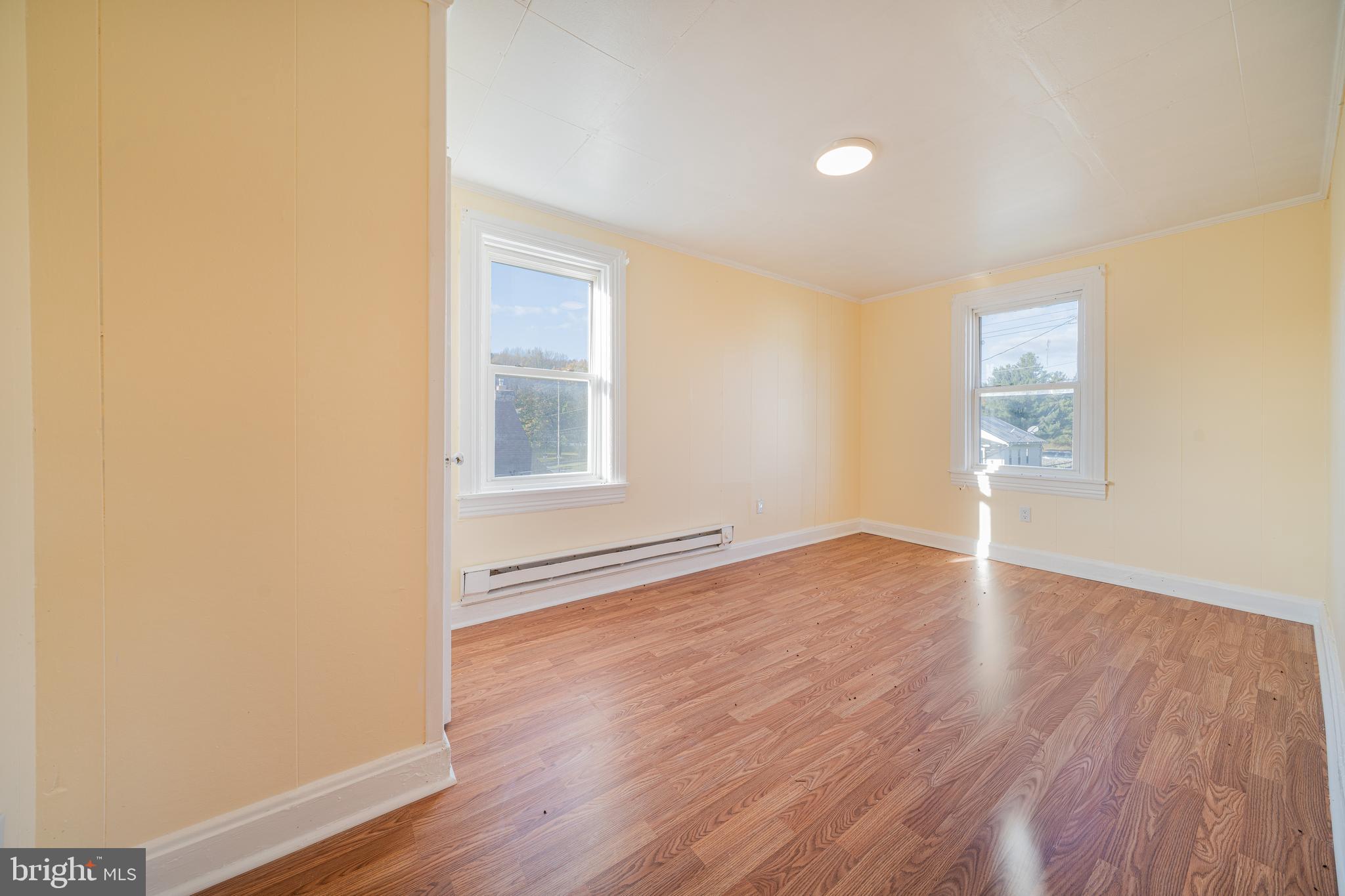 25329 Highfield Road Cascade, MD 21719 - Photo 39 of 51 an empty room with wooden floor and windows