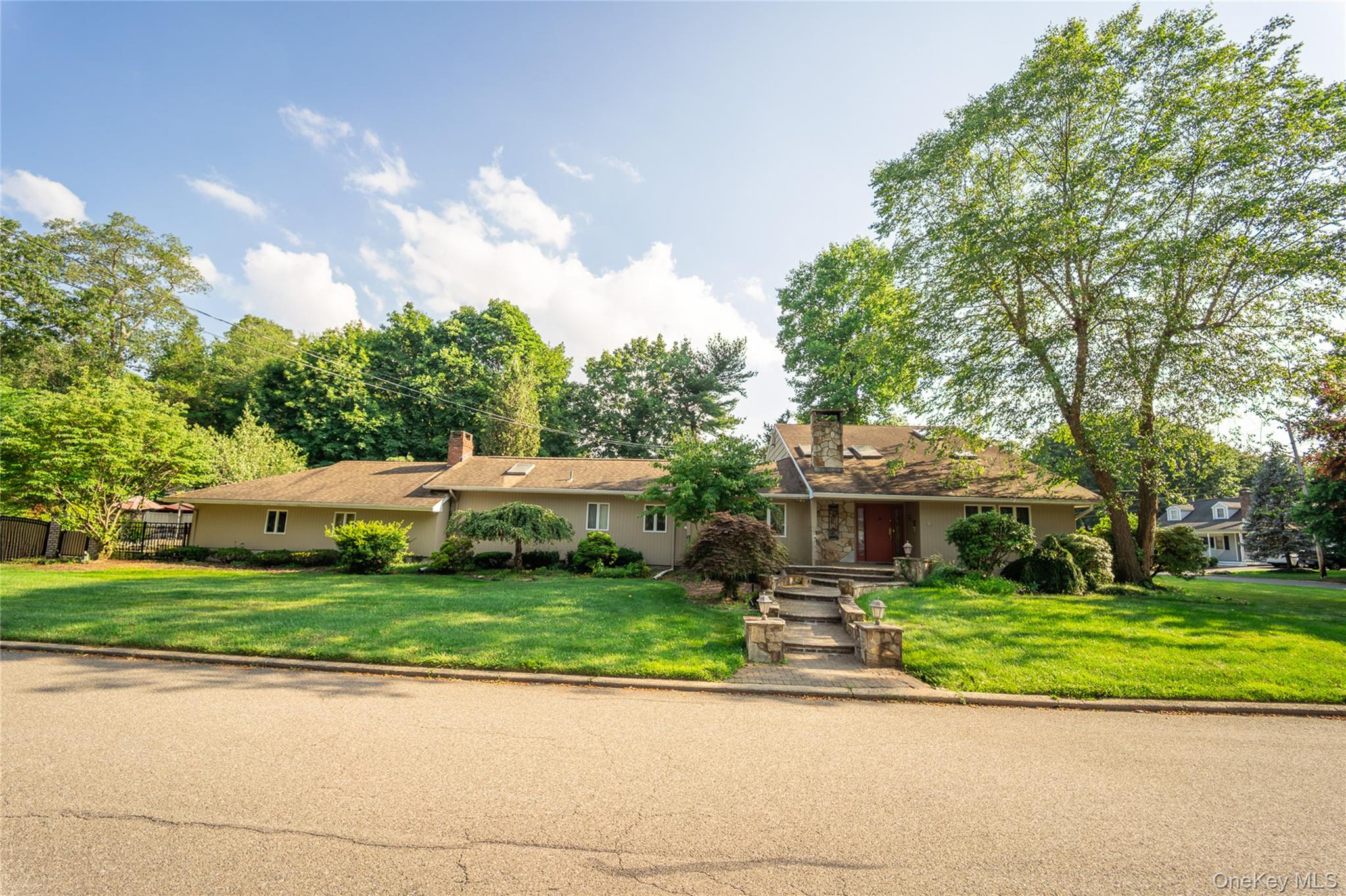 Ranch-style house with a front yard and a chimney