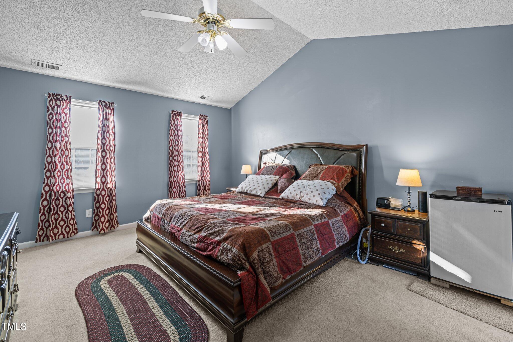1516 Harvey Johnson Road Raleigh, NC 27603 - Photo 17 of 41 a bedroom with a bed and a chandelier