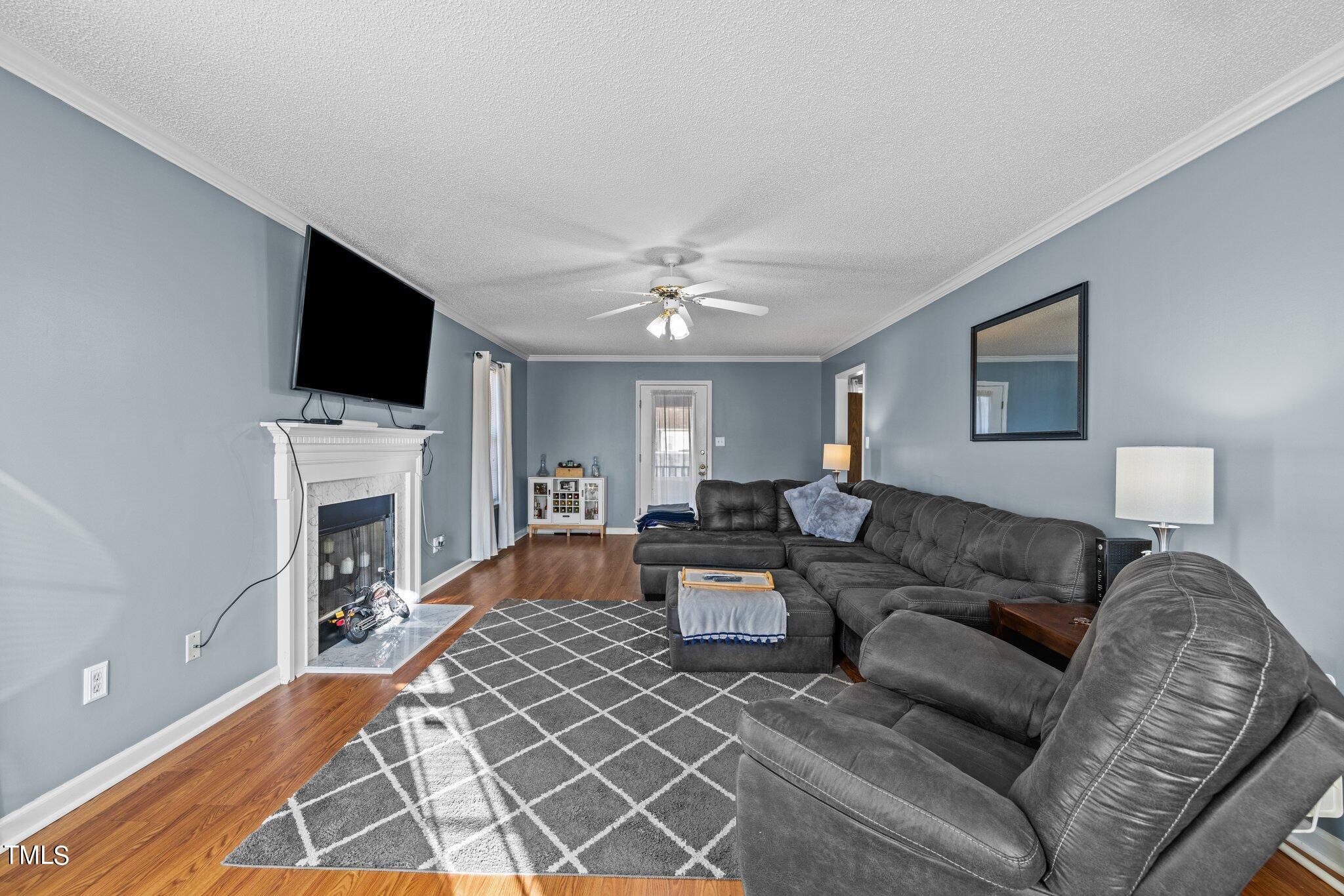 1516 Harvey Johnson Road Raleigh, NC 27603 - Photo 3 of 41 a living room with fireplace furniture and a flat screen tv