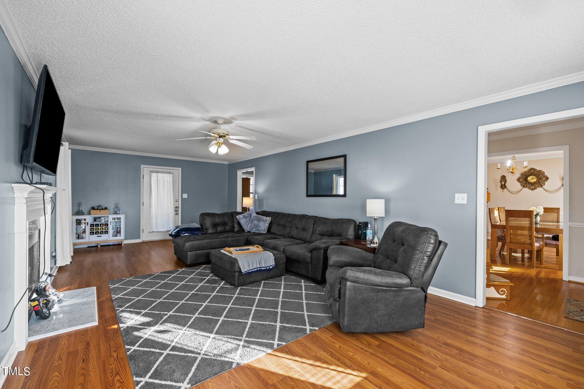 1516 Harvey Johnson Road Raleigh, NC 27603 - Photo 4 of 41 a living room with fireplace furniture and a flat screen tv