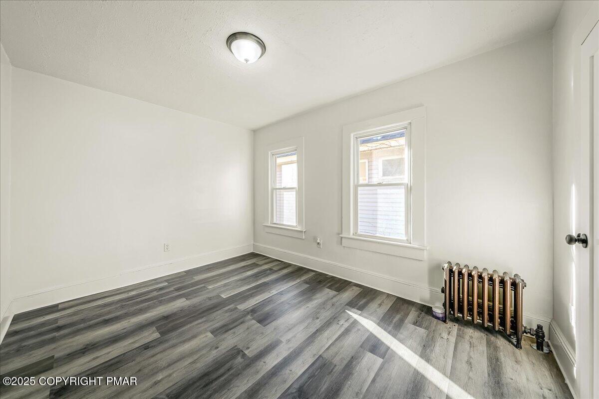 1057 Euclid Avenue Scranton, PA 18504 - Photo 13 of 23 an empty room with wooden floor and windows