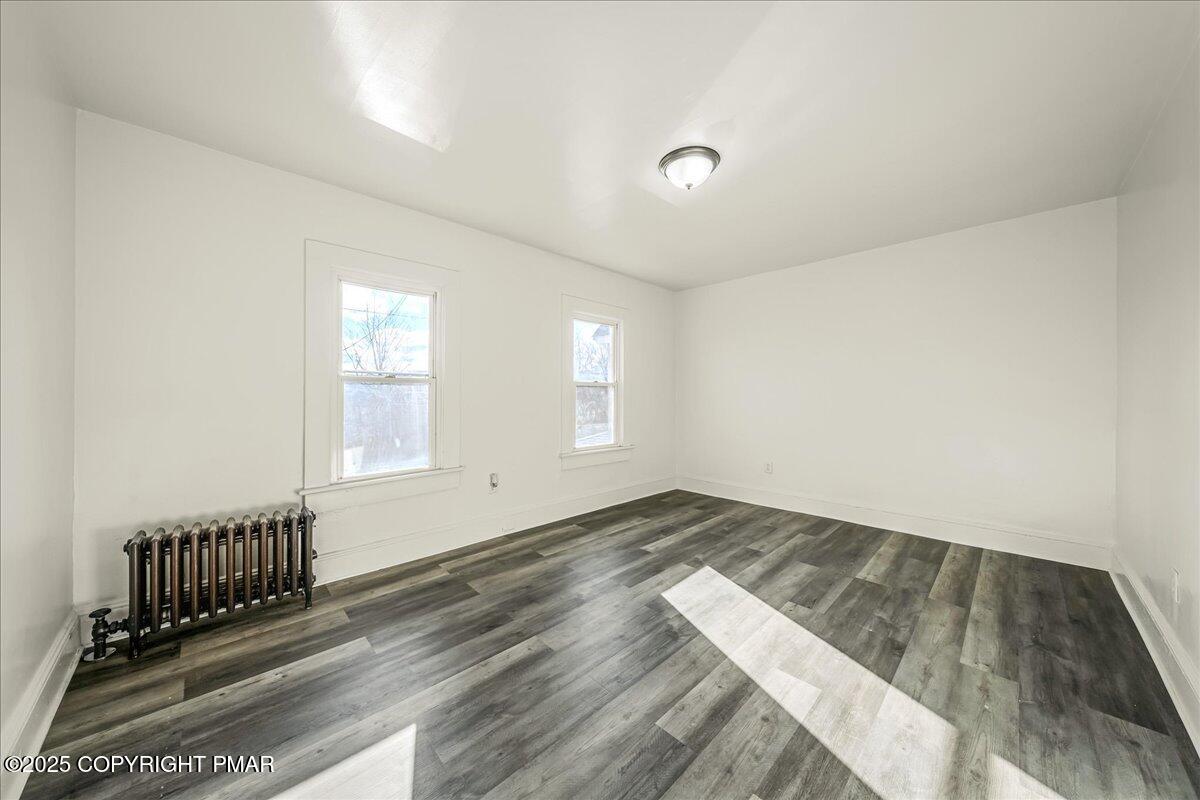 1057 Euclid Avenue Scranton, PA 18504 - Photo 15 of 23 an empty room with wooden floor and windows