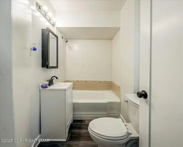 a white toilet sitting next to a bathroom sink