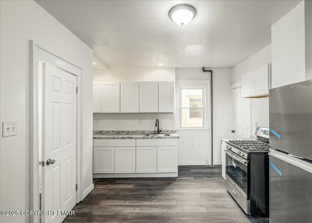 1057 Euclid Avenue Scranton, PA 18504 - Photo 6 of 23 a kitchen with a sink stove and refrigerator