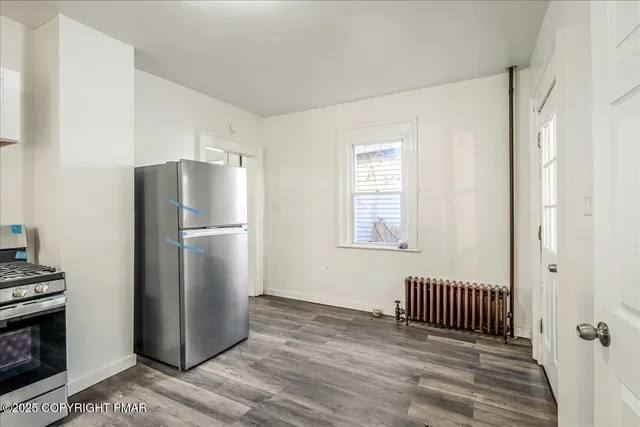 a kitchen with a refrigerator and a window