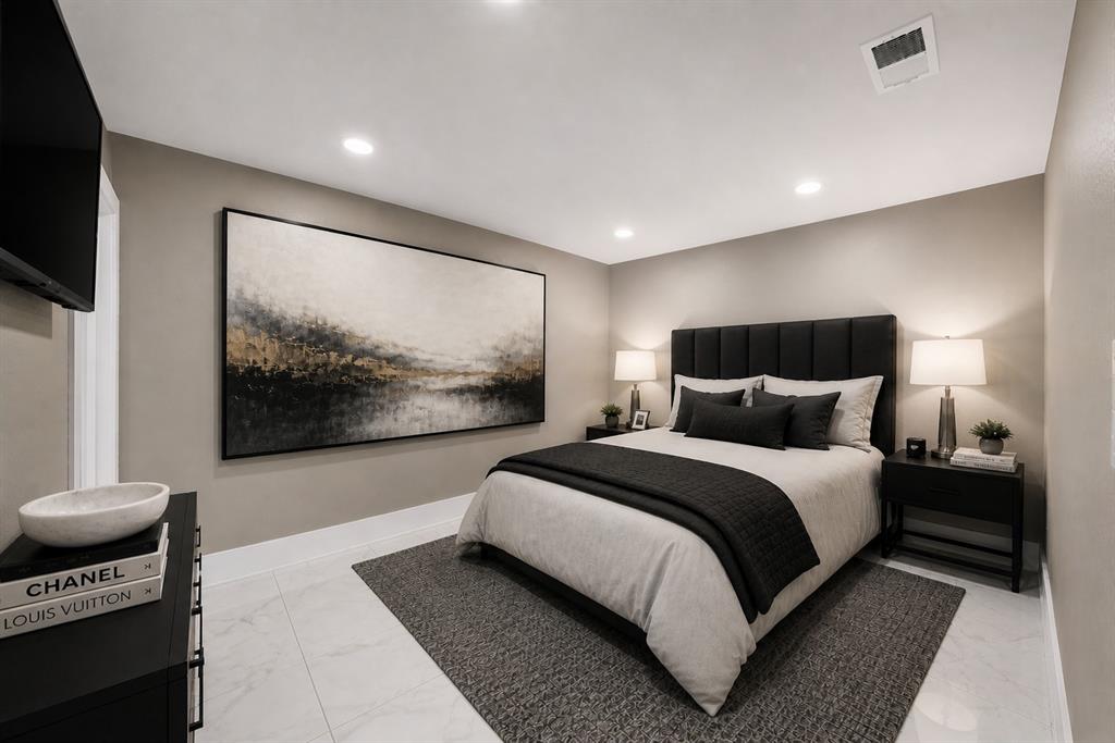 620 East 6th Street Springtown, TX 76082 - Photo 10 of 40 a bedroom with a bed and a flat screen tv