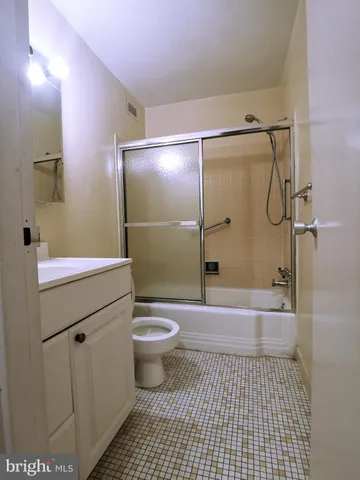 a bathroom with a toilet a sink and shower