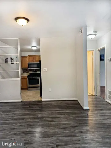 a view of a refrigerator in kitchen and wooden floor