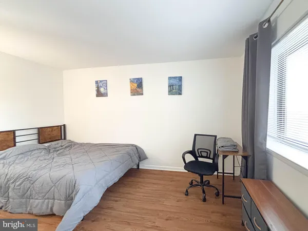 a bedroom with a bed a chair and a window