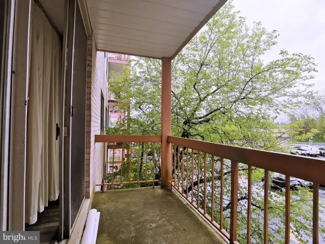 a view of a porch with a floor to ceiling window