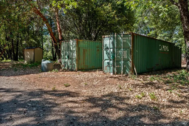 a backyard of a house with plants and trees