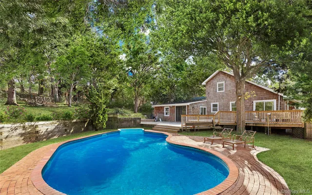 a view of a house with pool yard and a chairs