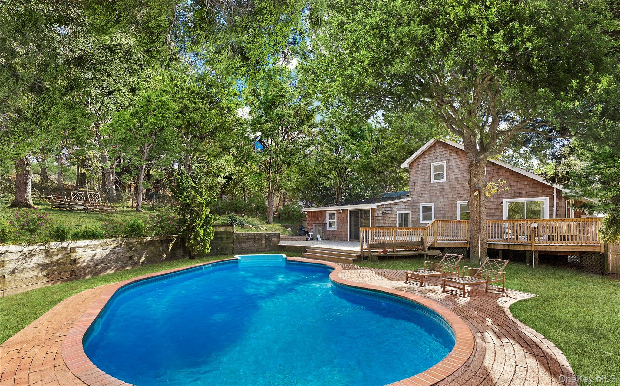 a view of a house with pool yard and a chairs