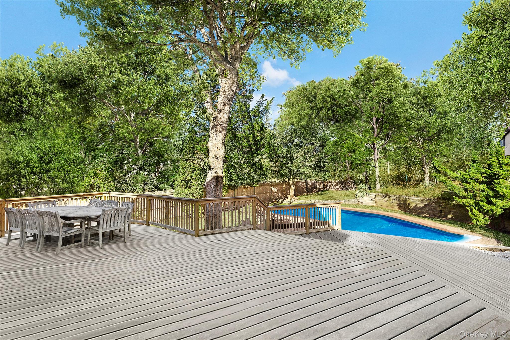 16 Peconic Road Hampton Bays, NY 11946 - Photo 11 of 13 a view of a wooden deck with chairs