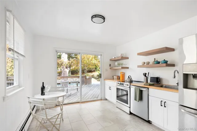 a kitchen with white cabinets and white appliances