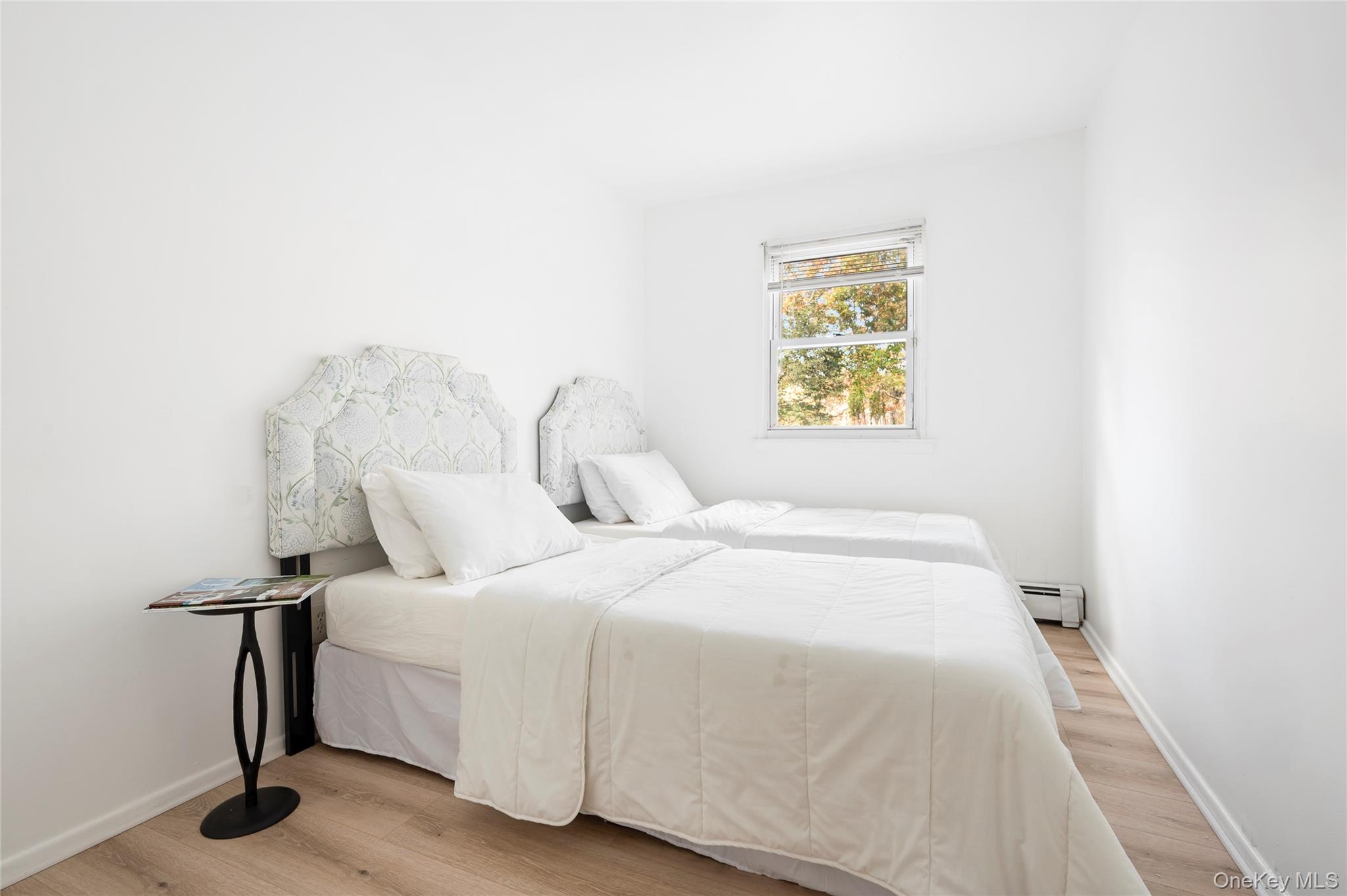 16 Peconic Road Hampton Bays, NY 11946 - Photo 6 of 13 a bedroom with a bed and a painting on the wall