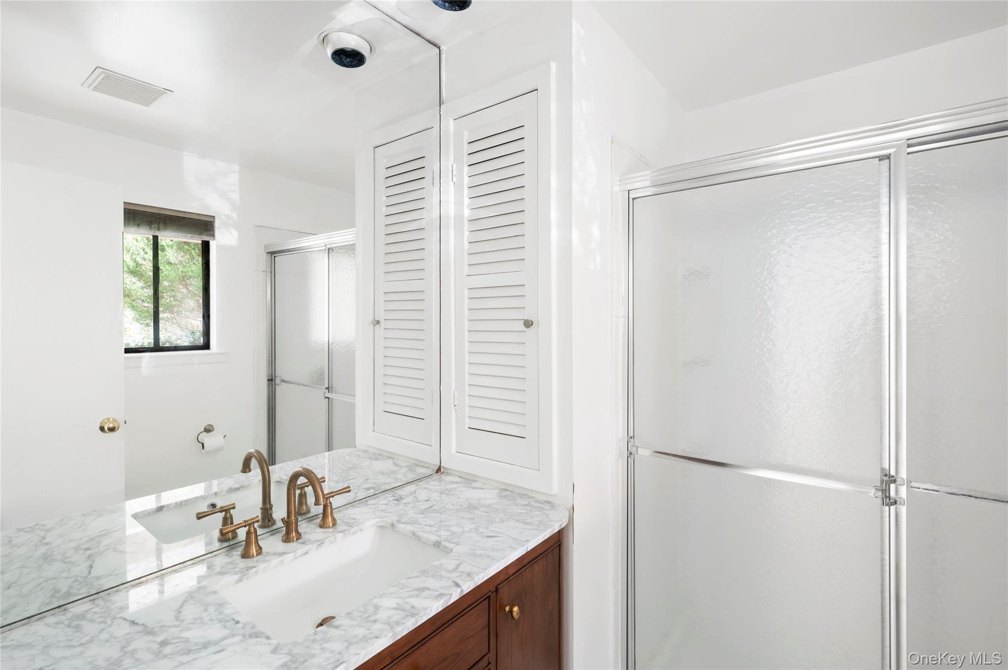 16 Peconic Road Hampton Bays, NY 11946 - Photo 7 of 13 a bathroom with a granite countertop sink mirror and double
