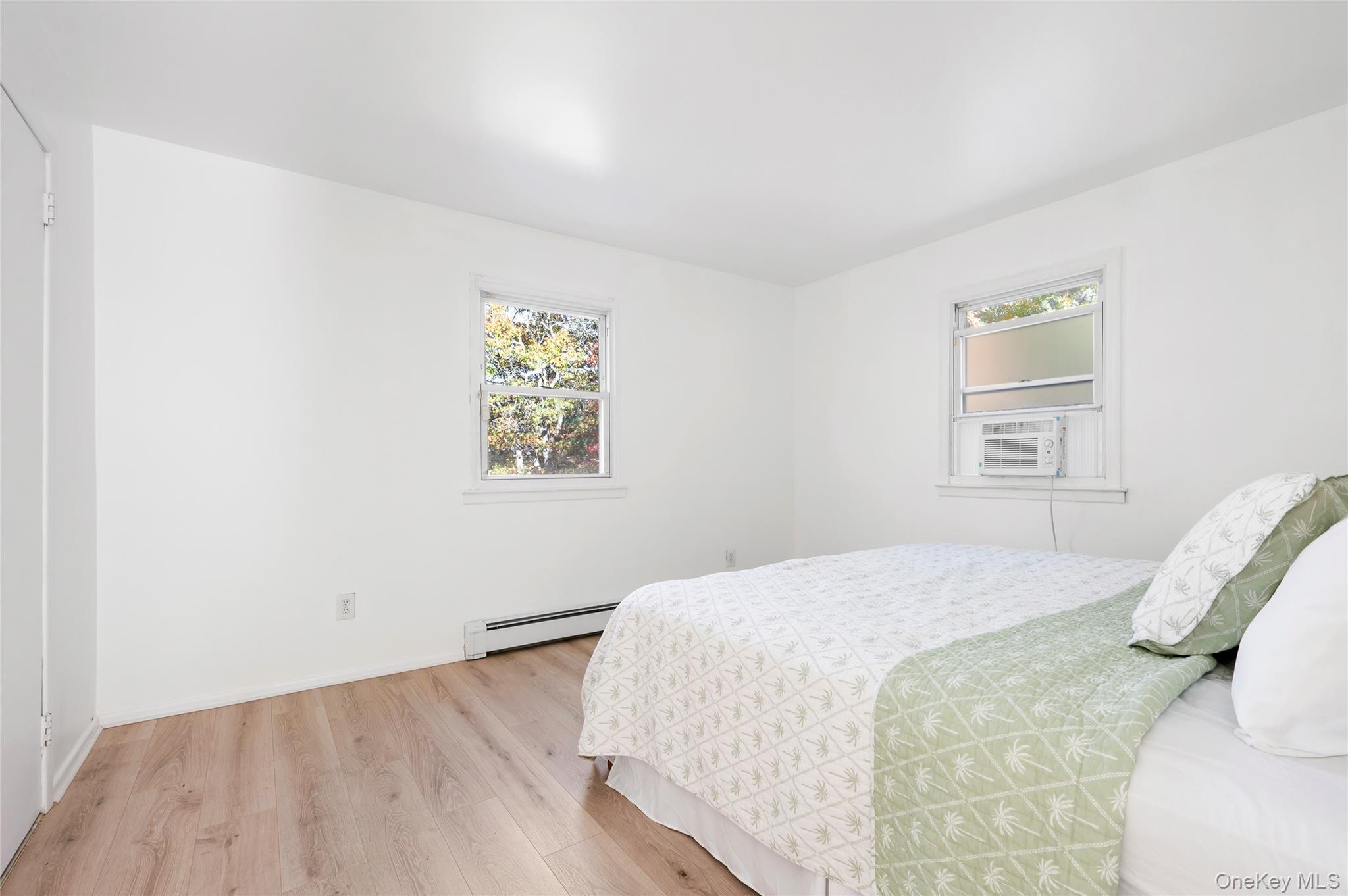 16 Peconic Road Hampton Bays, NY 11946 - Photo 9 of 13 a bedroom with a bed and a window