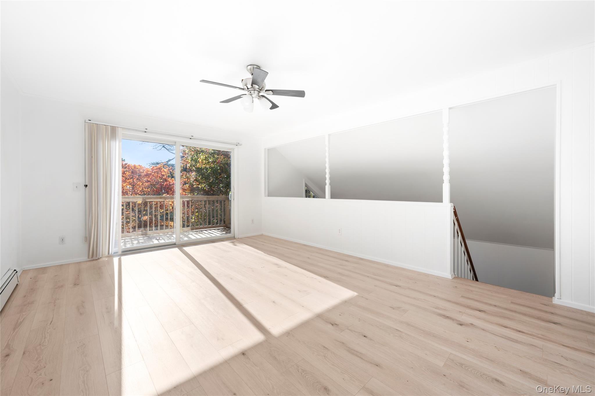 16 Peconic Road Hampton Bays, NY 11946 - Photo 10 of 13 a view of empty room with wooden floor and fan