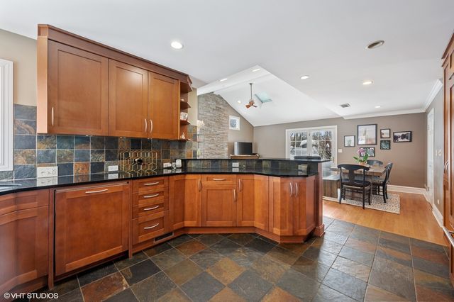 a kitchen with stainless steel appliances granite countertop a sink a stove counter space and cabinets