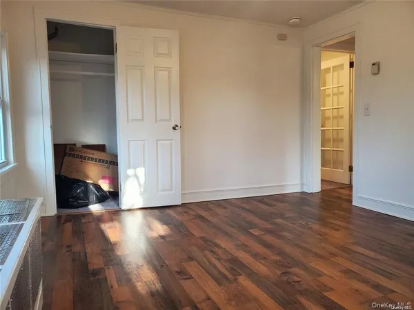 a view of a livingroom with wooden floor and a fireplace