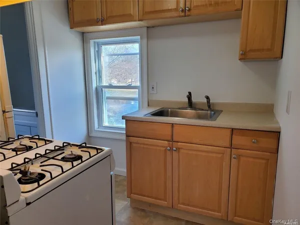a kitchen with a sink stove and cabinets