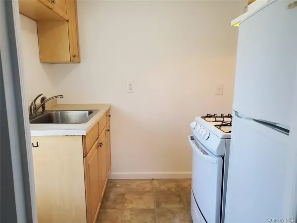 a utility room with sink dryer and washer