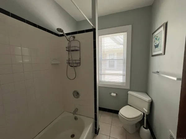 a bathroom with a granite countertop toilet sink and shower