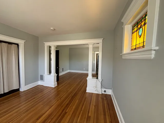 a view of a room with wooden floor and balcony