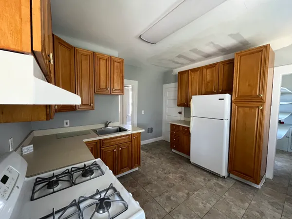 a kitchen with a stove a refrigerator and a stove