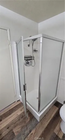 a bathroom with a glass door shower