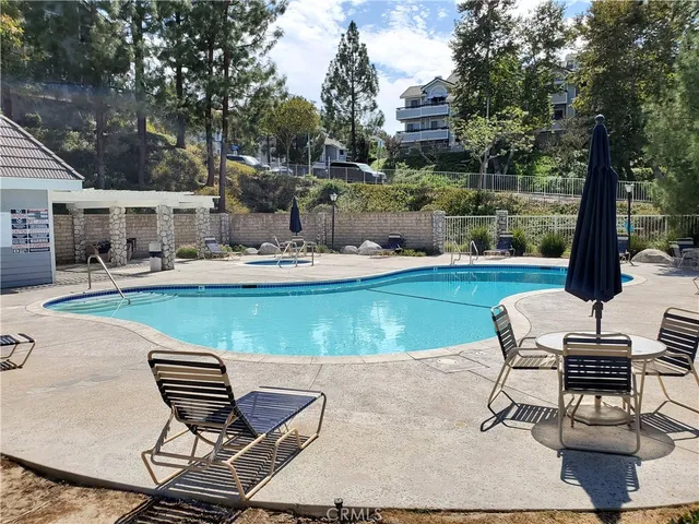a view of swimming pool with outdoor seating