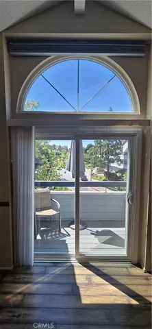a room that has a wooden floor and a large window