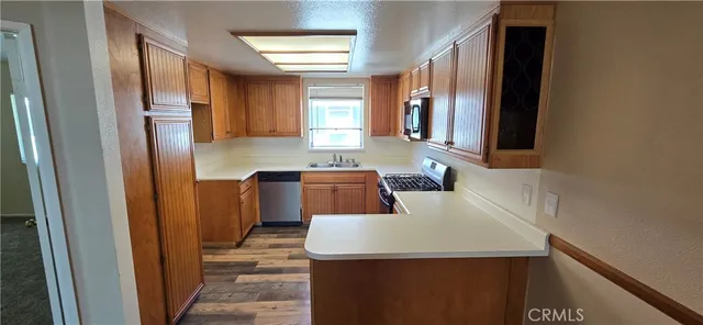 a kitchen with a sink a stove and a refrigerator