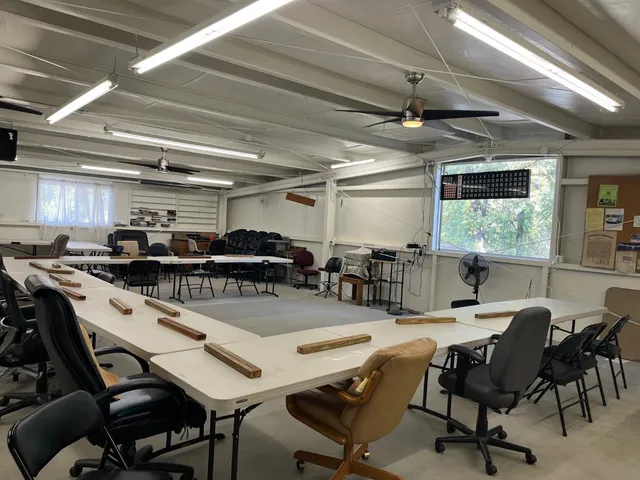 a room with lots of chairs and a chandelier