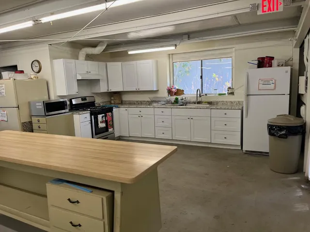 a kitchen with cabinets appliances and a counter top