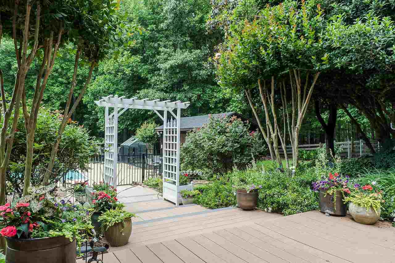 4924 Birchleaf Drive Raleigh, NC 27606 - Photo 15 of 19 Large decking areas leading to fenced in pool area with new fencing and trek maintenance free decking areas! Exterior Back