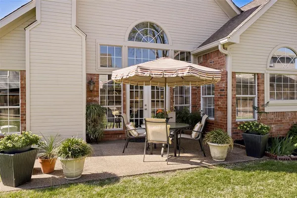 a view of a house with backyard porch and sitting area