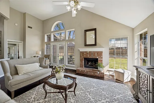 a living room with furniture a chandelier and a fireplace