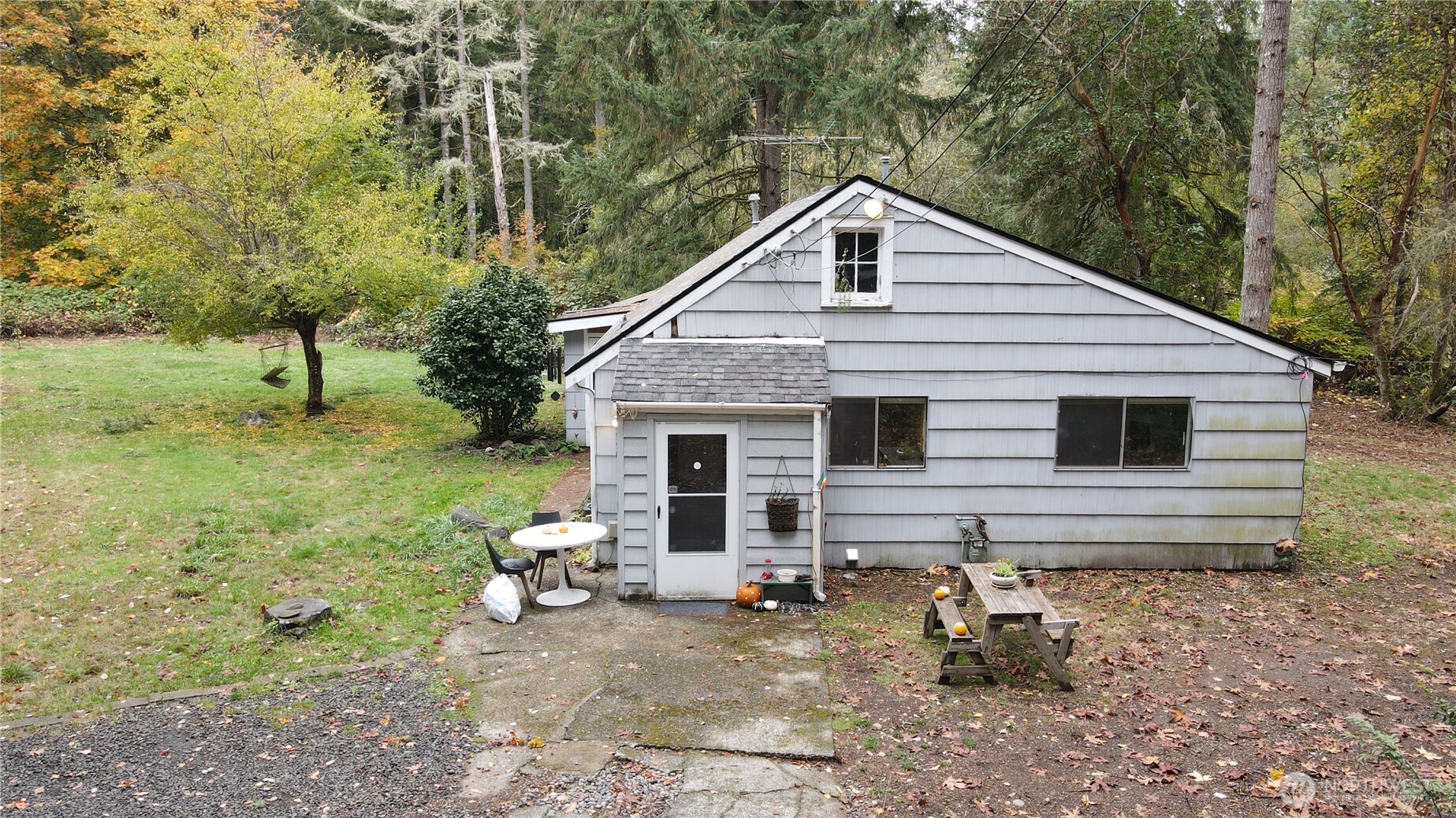 3225 Cooper Point Road Northwest Olympia, WA 98502 - Photo 19 of 40 a view of a house with a yard chairs and floor to ceiling window