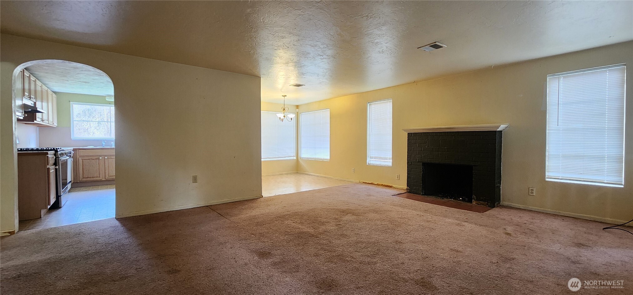 3225 Cooper Point Road Northwest Olympia, WA 98502 - Photo 21 of 40 a view of an empty room with a fireplace and a window