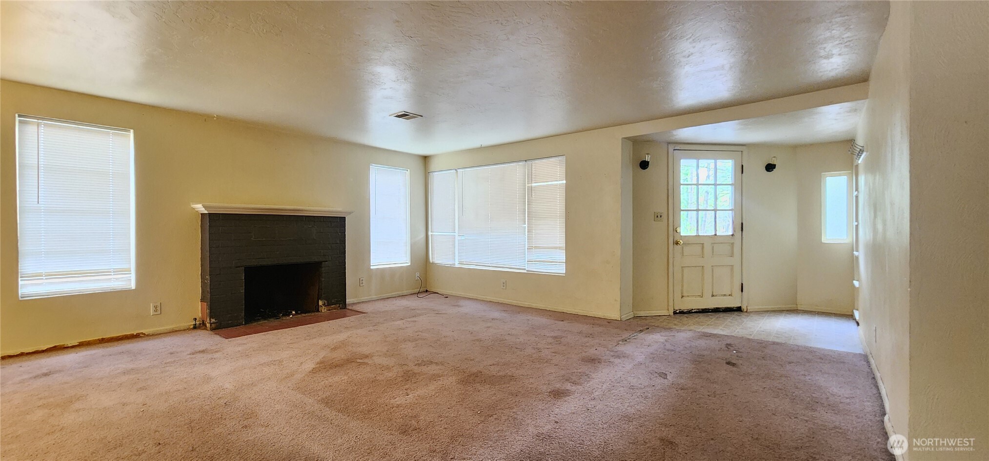 3225 Cooper Point Road Northwest Olympia, WA 98502 - Photo 22 of 40 an empty room with windows and fireplace
