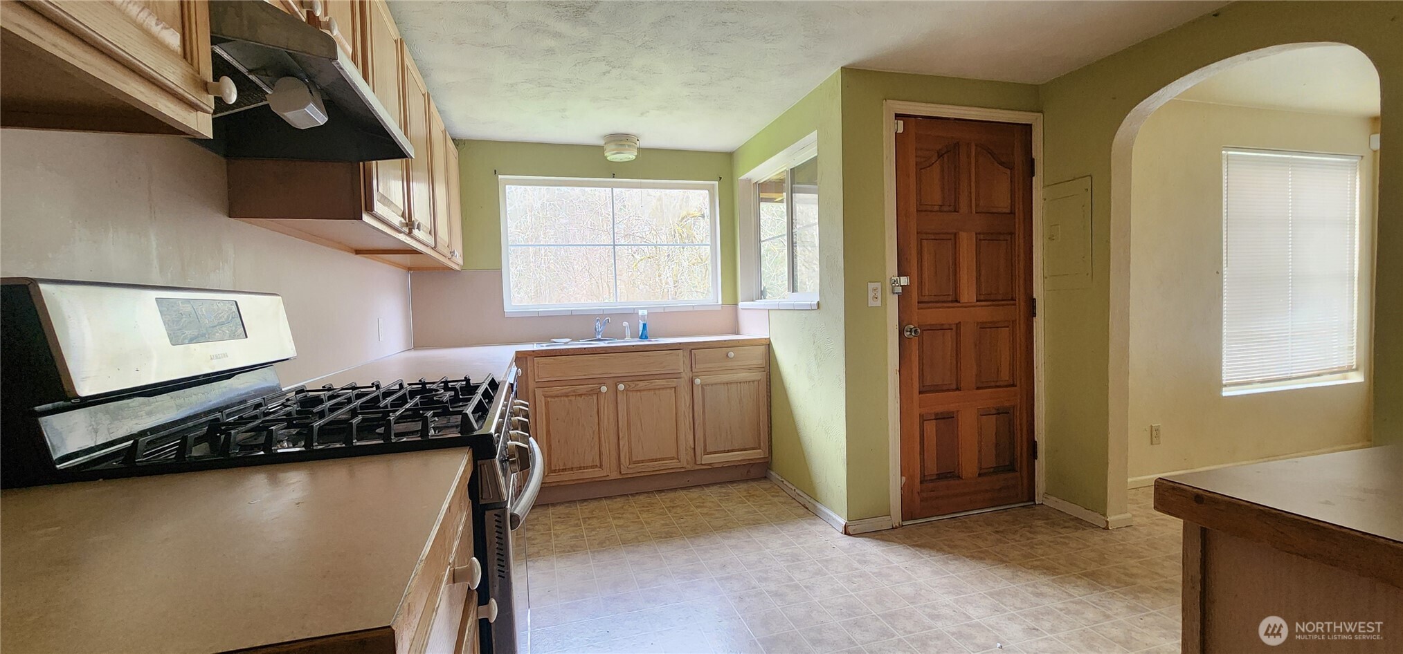 3225 Cooper Point Road Northwest Olympia, WA 98502 - Photo 25 of 40 a kitchen with stainless steel appliances granite countertop a stove a sink and a refrigerator
