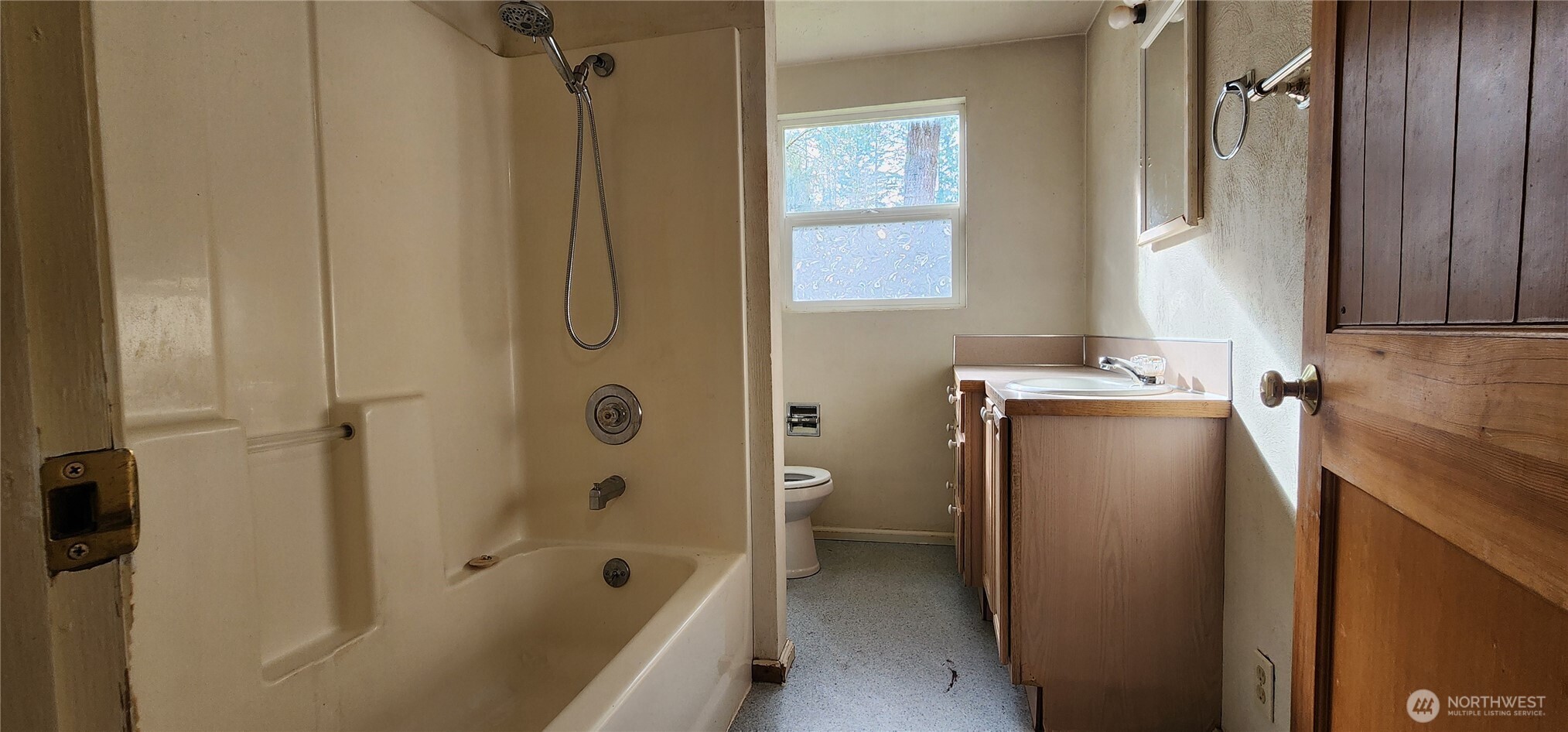 3225 Cooper Point Road Northwest Olympia, WA 98502 - Photo 28 of 40 a bathroom with a tub shower and a sink
