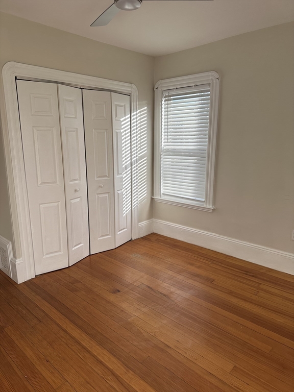 9 Station Road, Unit 2 Salem, MA 01970 - Photo 15 of 21 a view of an empty room with wooden floor and a window